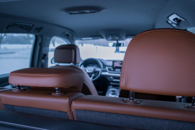 Photo by Marc-Antoine Dubé the inside of a vehicle with a brown leather seat