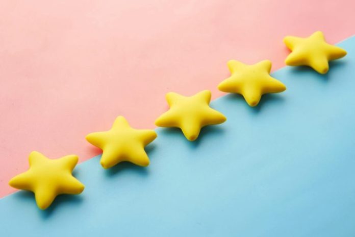 Photo by Towfiqu barbhuiya Yellow stars on pink and blue pastel background for rating or review concept.