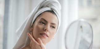 A serene and elegant woman enjoys a skincare ritual, enhancing her natural beauty in the comfort of her home.