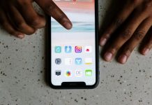 Why is it Important to Have a Celebrity Presence on Instagram? Close-up view of hands interacting with social media apps on a smartphone screen.