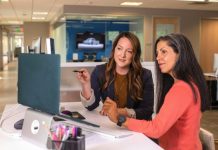 Why Businesses Need Data Lake Consulting two women sitting at a table looking at a computer screen