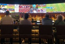 UI That Keeps Up: Designing for Rapid Game and Bet Changes a group of people sitting at a bar watching tv