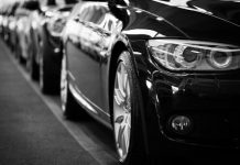 How Weather and Climate Impact Your Car’s Exterior – And How Ceramic Coating Helps Close-up black and white image of a luxury car line-up focusing on vehicle headlights.