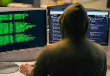 Steps Every Consumer Should Take After a Data Breach Hacker in hoodie working on multiple computer screens