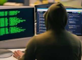 Steps Every Consumer Should Take After a Data Breach Hacker in hoodie working on multiple computer screens