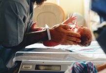What Are the Most Common Birth Injuries? person wearing gray shirt putting baby on scale