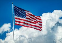 Is Becoming a U.S. Citizen Worth It? What to Know Before You Apply An american flag flying high in the sky