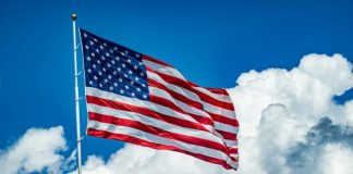 An american flag flying high in the sky