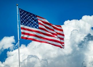 An american flag flying high in the sky