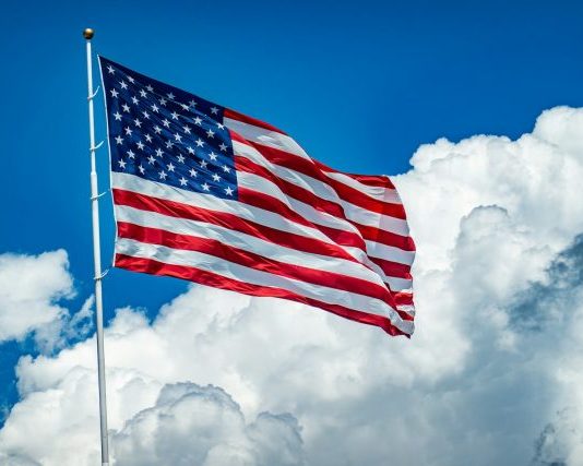 An american flag flying high in the sky