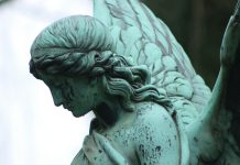 angel statue in grayscale photography