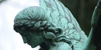 angel statue in grayscale photography