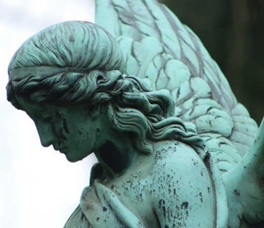 angel statue in grayscale photography