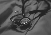 a black and white photo of a stethoscope on a bed