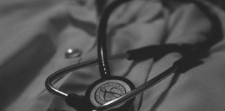 a black and white photo of a stethoscope on a bed