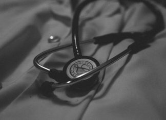 5 Long-Term Effects Patients May Experience After Medical Negligenc a black and white photo of a stethoscope on a bed