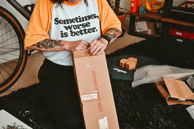 Photo by Nik a person with a box on the lap