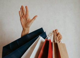 Why You Should Fight Shoplifting Charges Person waving from behind shopping bags