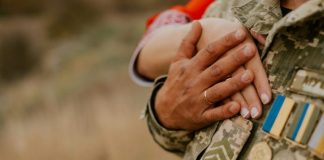 a close-up of hands holding coins