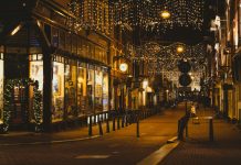 people walking on sidewalk during night time