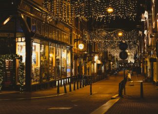 people walking on sidewalk during night time