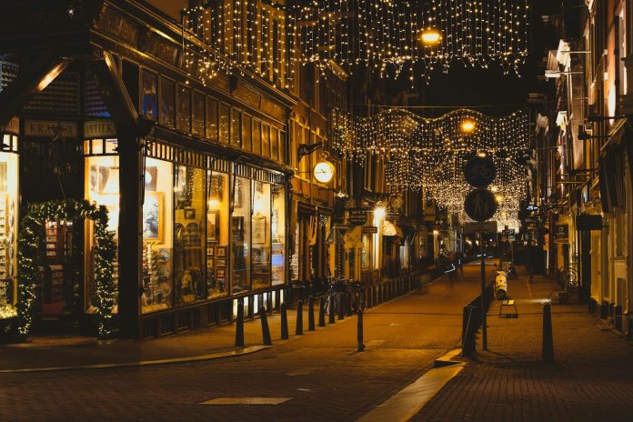 Photo by Dylan Freedom people walking on sidewalk during night time