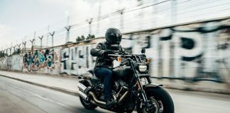 person riding motorcycle on concrete road