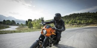 person driving orange motorcycle