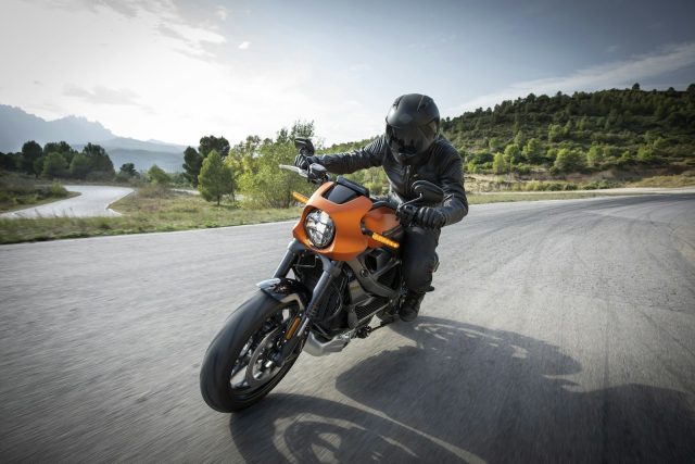 Photo by Harley-Davidson person driving orange motorcycle