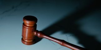 a wooden judge's hammer sitting on top of a table