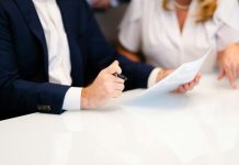 The First Two Weeks After a Workplace Injury: Myths That Cost Workers Real Money a man and a woman sitting at a white table