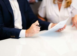 The First Two Weeks After a Workplace Injury: Myths That Cost Workers Real Money a man and a woman sitting at a white table