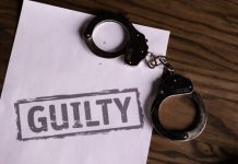 Why Innocent People Plead Guilty: The Pressure Points Inside a Criminal Case Top view of handcuffs on paper with 'GUILTY' text, symbolizing a verdict or crime.