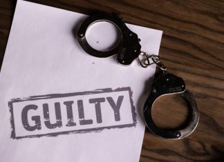 Why Innocent People Plead Guilty: The Pressure Points Inside a Criminal Case Top view of handcuffs on paper with 'GUILTY' text, symbolizing a verdict or crime.