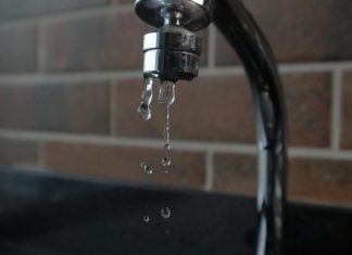 The Water Pressure Myths That Keep Building Owners Chasing the Wrong Fix a faucet with water running from it's spout