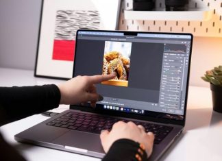 A person sitting in front of a laptop computer