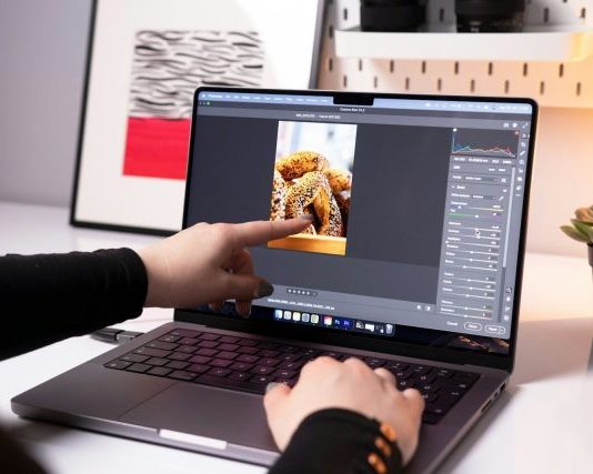 How to Create Engaging Videos with AI Video Editing Tools A person sitting in front of a laptop computer