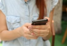 person holding using iPhone X
