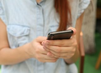 person holding using iPhone X