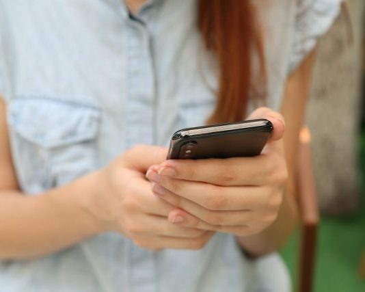 The Custody App Message Log Is Deciding Modification Cases person holding using iPhone X